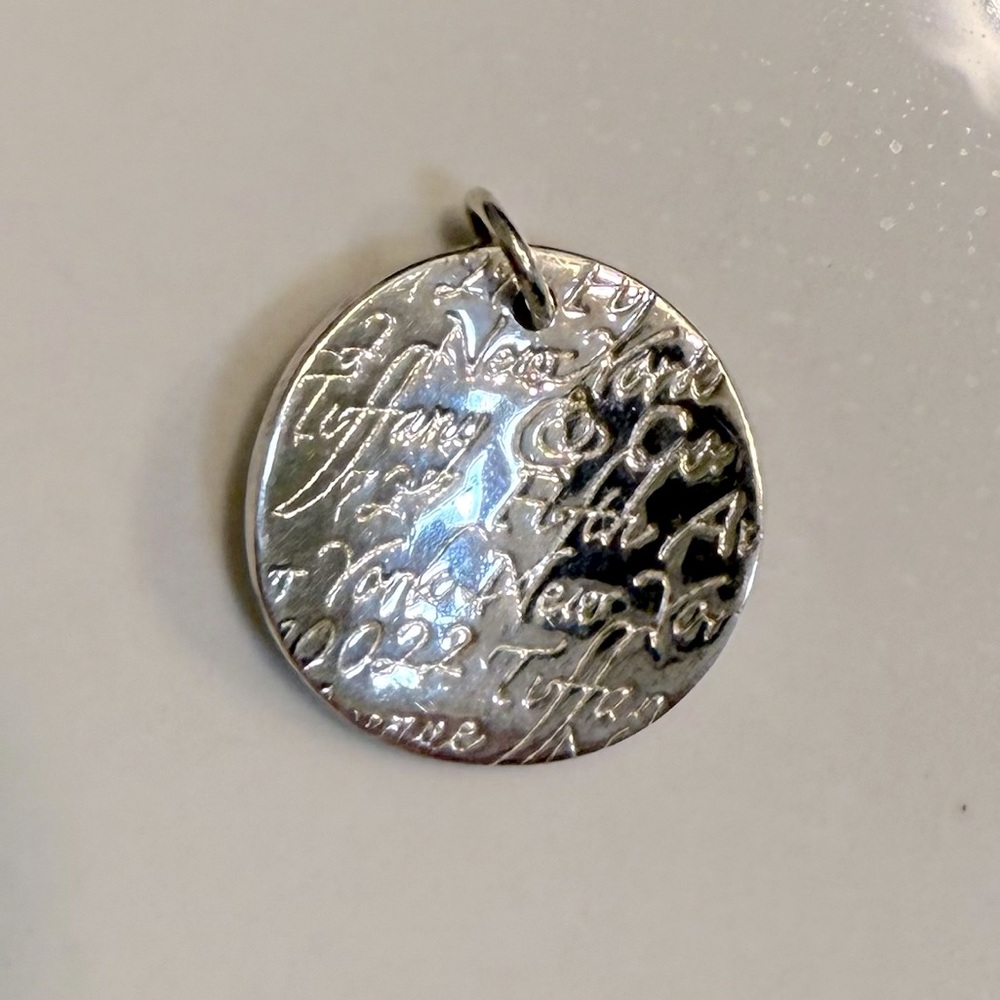 Authentic Tiffany & Co wavy round circle charm pendant. Sterling silver.